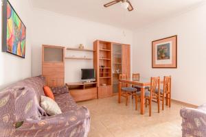 ein Wohnzimmer mit einem Sofa und einem Tisch in der Unterkunft Apartamento Valle de Abdalajis in Málaga