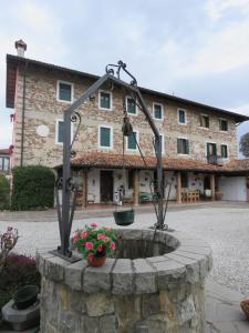 a stone fountain in front of a building at Affittacamere Maria Stella in Udine