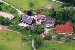 an aerial view of a house with a red roof at Exklusive Ferienwohnung auf dem Romanshof - Schwarzwald Plus Gastgeber in Loßburg