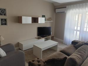a living room with a couch and a tv at Apartamento centro Ribadeo in Ribadeo