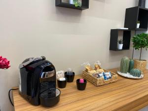 a coffee maker on a counter with a basket of food at TH LUXURY fly in Catania