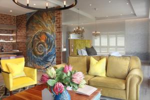 a living room with a couch and a table at Hermanus Boutique Guest House in Hermanus