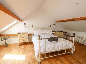 A bed or beds in a room at The Coach House