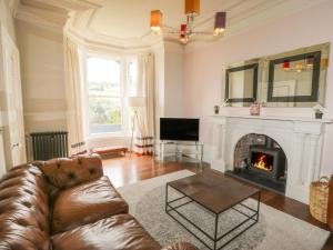 a living room with a couch and a fireplace at Ash Villa in Holmfirth