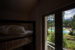 a bedroom with a bunk bed next to a window at HI Melgaco - Pousada de Juventude in Melgaço
