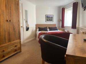 a bedroom with a bed and a couch in it at Byways Serviced Apartments in Salisbury