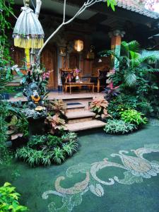 a garden with stairs and plants in front of a house at Praety Home Stay in Ubud