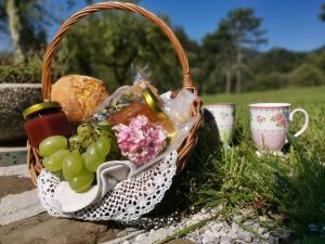 a basket of grapes and bread and two cups at Apartment Lošč - Podbela in Breginj