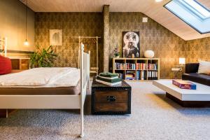 a bedroom with a bed and a couch at Wohlfühloase mit Blick auf Trier in Trier