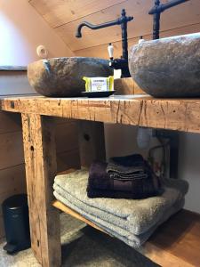 a wooden shelf with two sinks and towels on it at L'Alpage de la Bergerie apartment in a cosy farmhouse ! in Nâves-Parmelan