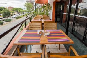 a row of tables and chairs on a balcony at Hotel Flamingo Irapuato in Irapuato