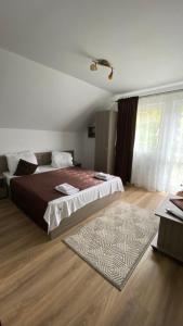 Postel nebo postele na pokoji v ubytování Regina Munților B