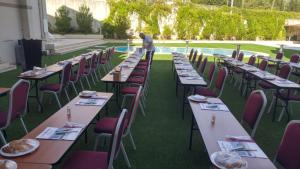 a row of tables and chairs with food on them at Tuna Hotel in Muğla