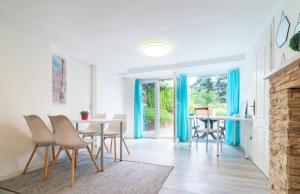 a dining room with blue curtains and a table and chairs at Cosy and Colorful apartment Szentendre in Szentendre