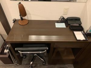 an office desk with a phone and a phone at Ochanomizu Inn in Tokyo
