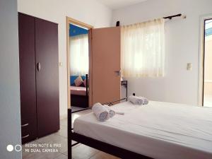 a bedroom with a bed with two towels on it at Apartments Onar in Argostoli