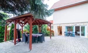 a pavilion with a table and chairs on a patio at Cosy and Colorful apartment Szentendre in Szentendre