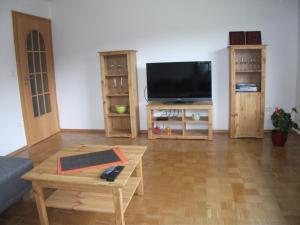 a living room with a tv and a coffee table at Ferienwohnung Annemarie in Gernsbach