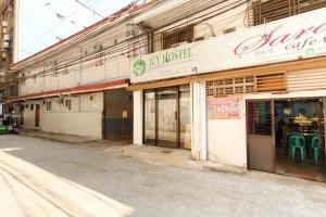 an empty street in front of a store at RedDoorz near OWWA Pasay in Manila