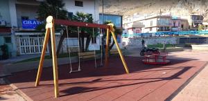 a playground in a city with a swing at La Casetta di Nonna Anna in Palermo