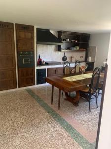 a kitchen with a wooden table and chairs in it at B&B Le Casette in SantʼOnofrio