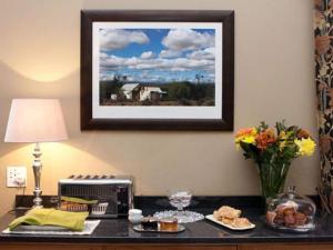 a desk with a microwave and a picture on the wall at Bellstone B&B in Pretoria