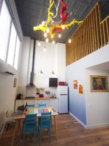 a kitchen with a table and some blue chairs at FABRIQ apartment in Alicante