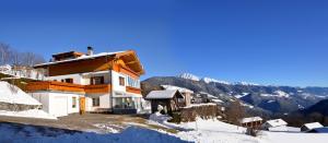 a house on top of a snow covered mountain at App. Haselstaude in Maranza