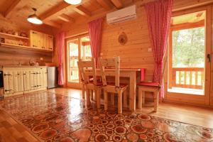a dining room with a table and chairs in a cabin at Riverside Apartments in Otočac