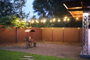 a fence with lights and a bike in a yard at Apple House in Mykulychyn
