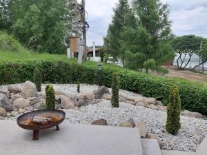 a rock garden with a bowl in the middle at VN Ľuboreč - Rekreačná chata in ľuboreč