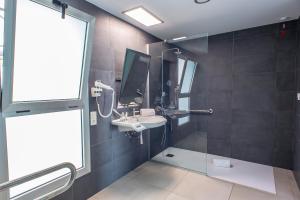 a bathroom with a sink and a mirror at Hotel Taimar in Costa Calma