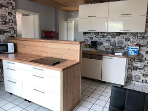 a kitchen with white cabinets and a counter top at Carolinger Hüttendorf in Weyer +37 photos