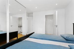 a bedroom with a bed and a mirror at aday - Apartment suite Aalborg Center in Aalborg