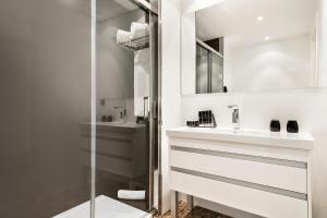 a bathroom with a sink and a mirror at Melia Sitges in Sitges