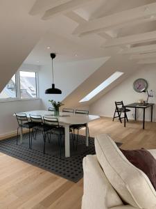 a dining room with a table and chairs in a room at aday - Big 3 Bedroom Apartment - Heart of Aalborg in Aalborg