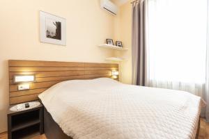 Ένα ή περισσότερα κρεβάτια σε δωμάτιο στο GoodRest on Deribasovska 19