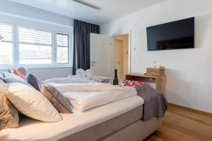 Televízia a/alebo spoločenská miestnosť v ubytovaní Apartments Galumbo - bleiben & genießen