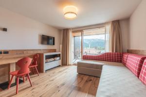 a living room with a couch and a fireplace at Hotel Bellavista in Cavalese