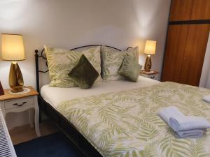 A bed or beds in a room at Karmelita Boutique Apartman