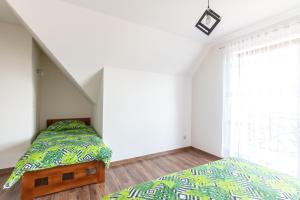Postel nebo postele na pokoji v ubytování Za Przylaskiem