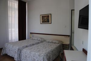 Postel nebo postele na pokoji v ubytování Hôtel Royal