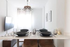 a dining room table with bowls and glasses on it at Town Hall in Bilbao