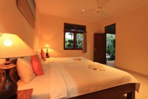 A bed or beds in a room at Duana's Homestay