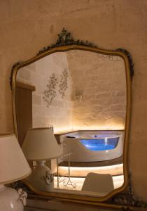 
a room with a mirror and a painting on the wall at Le Dodici Lune in Matera
