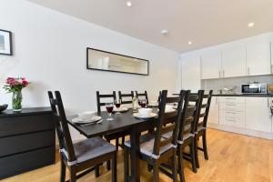 a dining room with a black table and chairs at Fantastic Stays at Camden in London