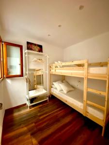 two bunk beds in a room with wooden floors at Apartaments Chenin Blanc-Priorat- in Cornudella