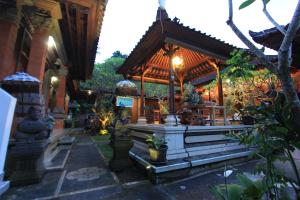 a building with a fountain in front of it at Duana's Homestay in Ubud +16 photos