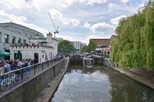 a river with a group of people standing on a bridge at Fantastic Stays at Camden in London