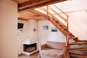 a living room with a couch and a fireplace at Residence SoleNeveSila B&B in Camigliatello Silano